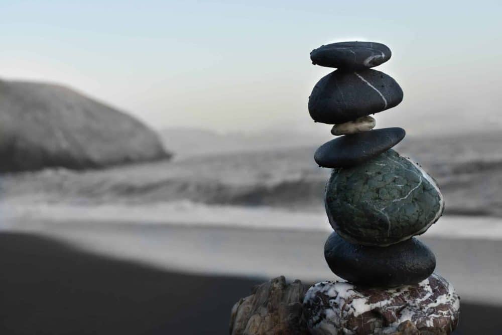 Balanced stones representing stability and decision-making under uncertainty